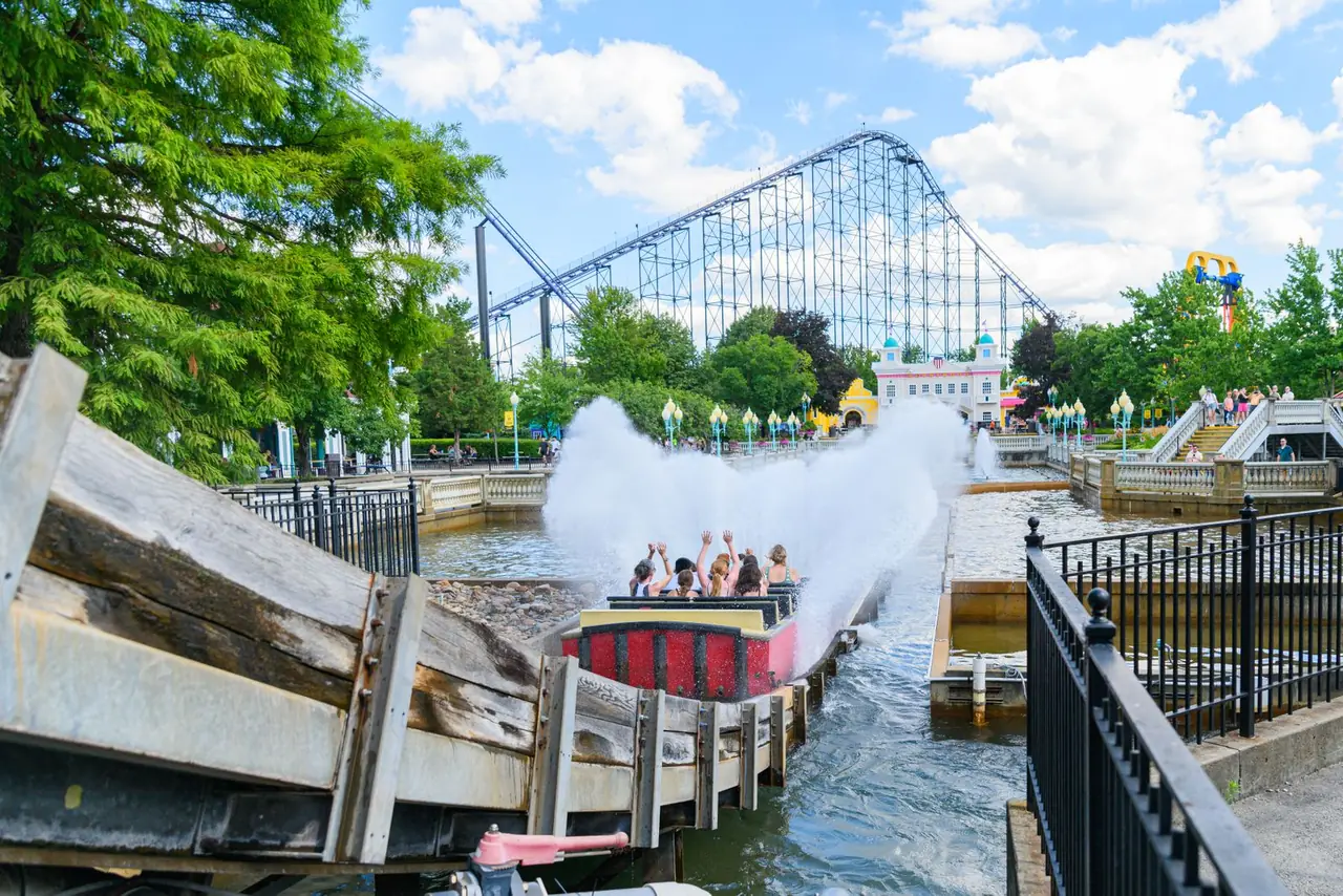 Thrilling water ride splashing down at a lively amusement park.